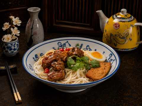 辣味麵碗鋪上滷肉、香菜與滷蛋